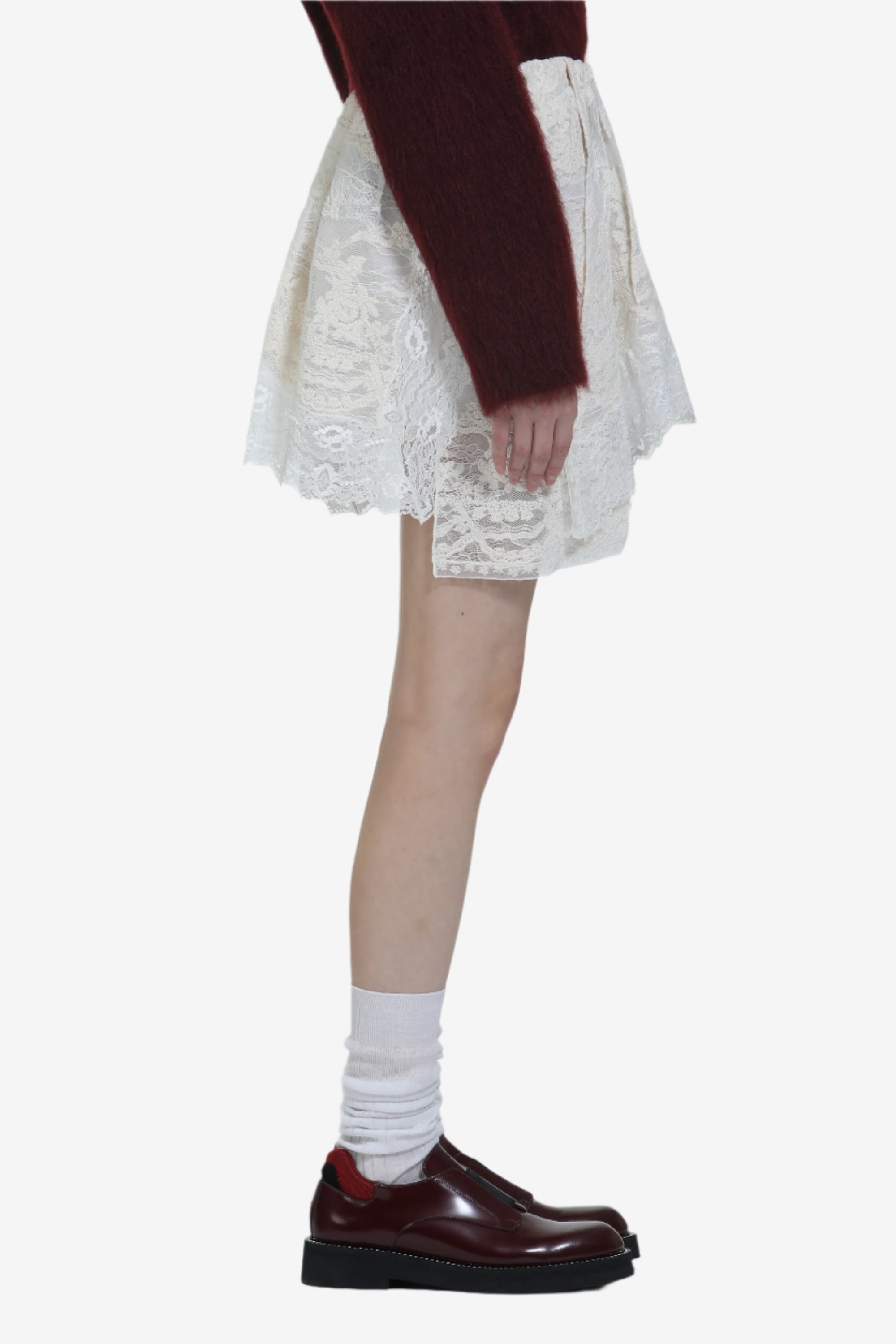 Lace miniskirt with irregular hem