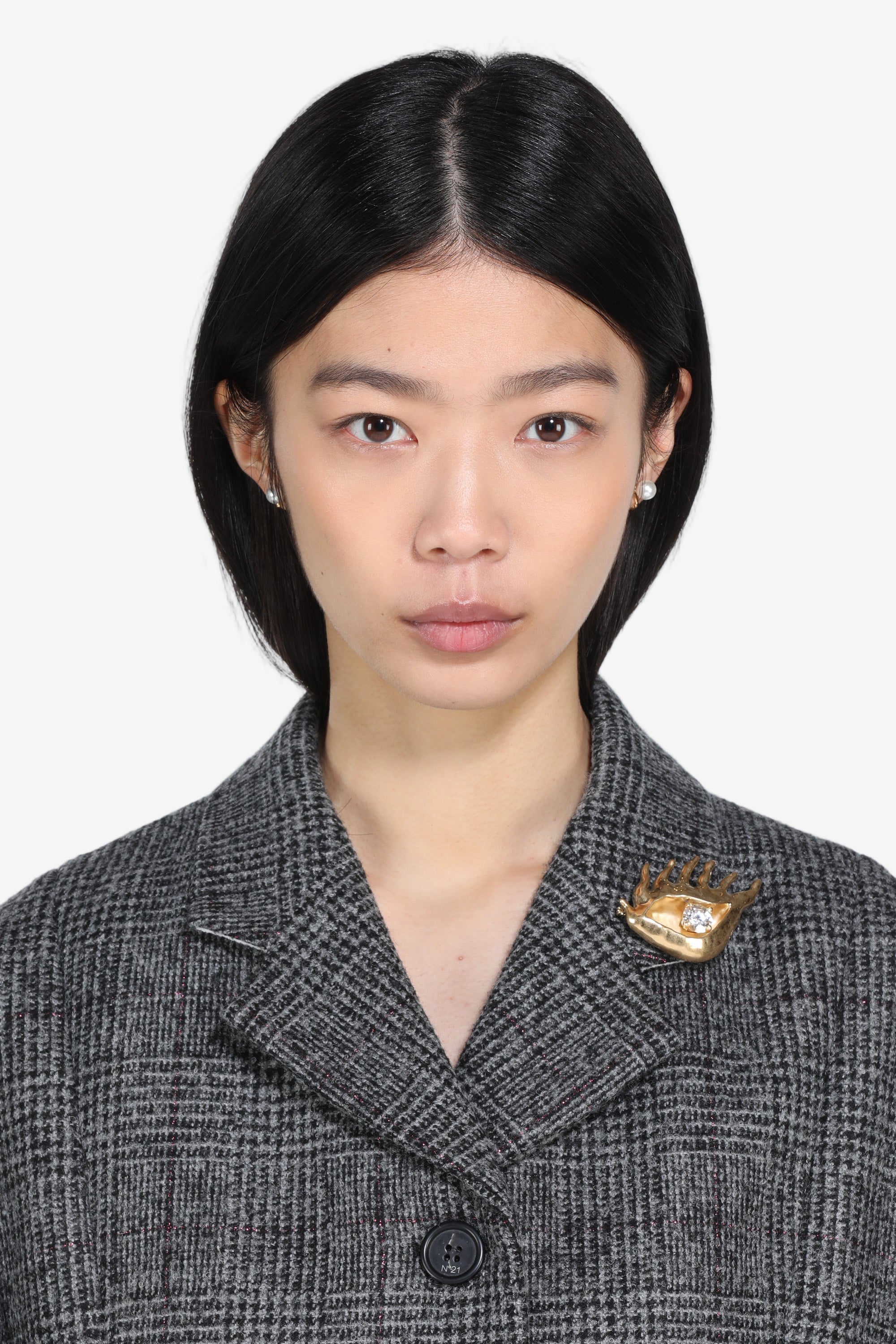 Golden eye-shaped brooch